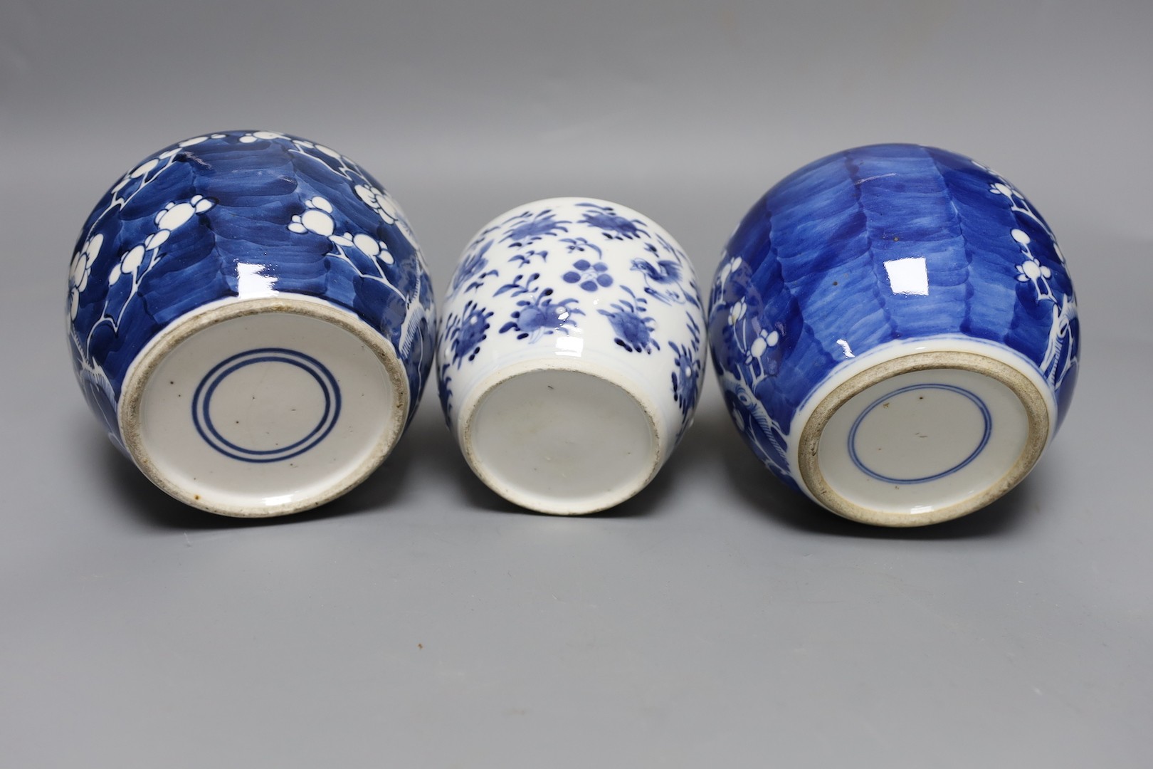 Two 19th century blue and white prunus jars and a barrel jar and cover. 12cm